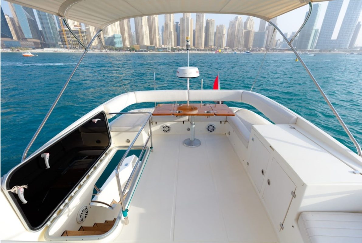 Image of the stern of a boat featuring tables and sofas