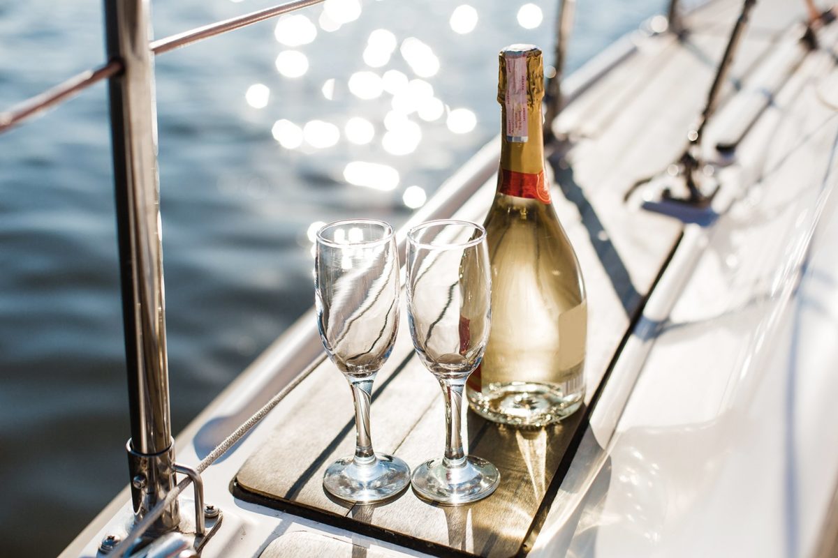 Champagne bottle with glasses on a boat