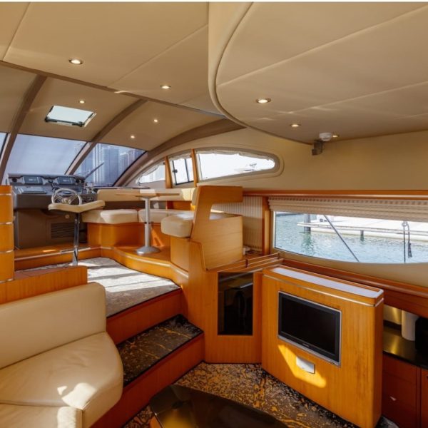 Image of the stern of a boat featuring tables and sofas