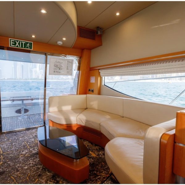 Image of the stern of a boat featuring tables and sofas