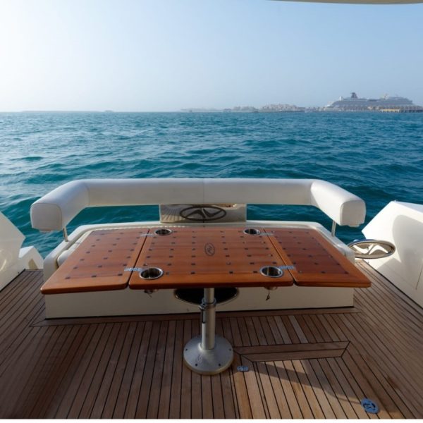 Image of the stern of a boat featuring tables and sofas