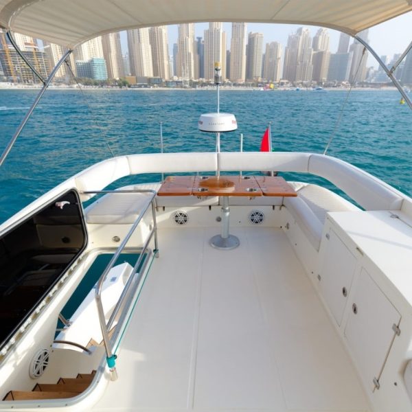 Image of the stern of a boat featuring tables and sofas